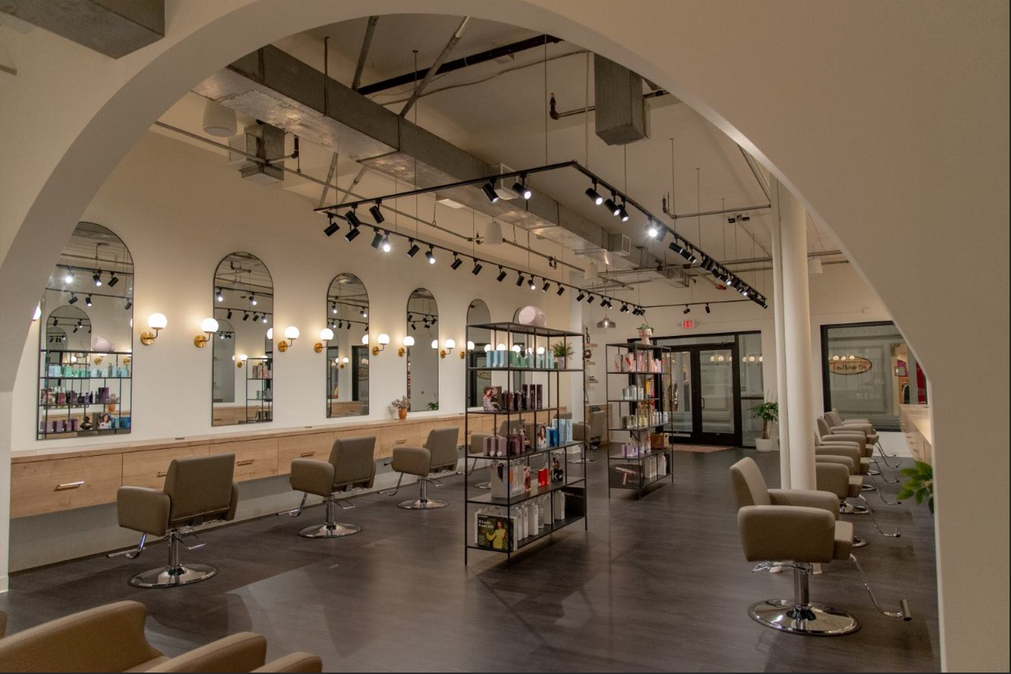 A hair salon with a lot of chairs and mirrors.