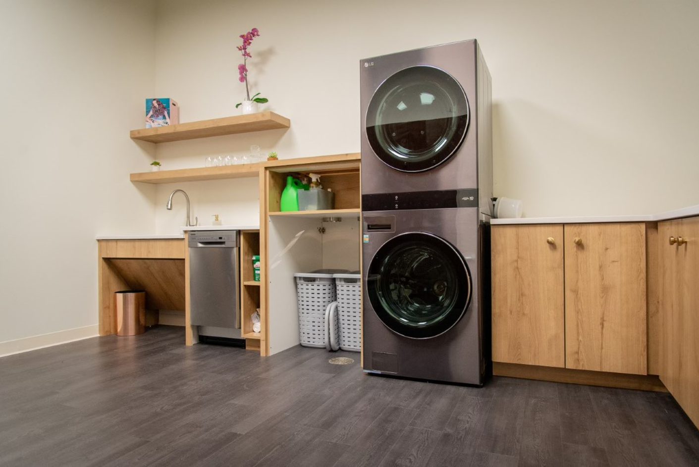 A laundry room with a washer and dryer stacked on top of each other.
