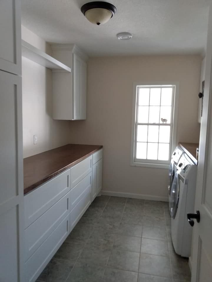 A laundry room with a washer and dryer and a window