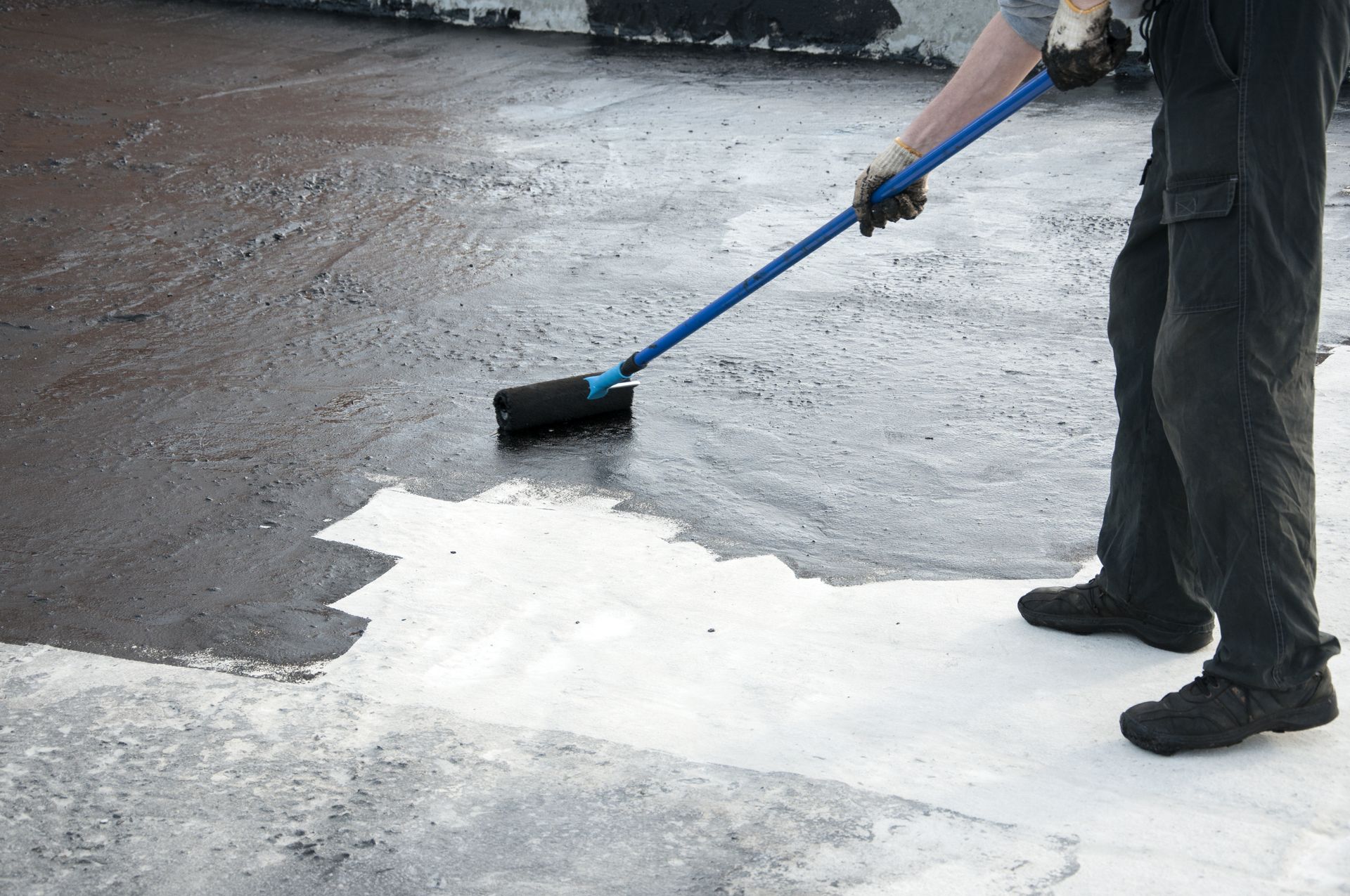 Person in protective suit spraying a large metal structure, producing a mist — TMP Painting Services in Bucasia, QLD
