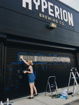 Man Painting the Store — Brewing Company in Jacksonville, FL