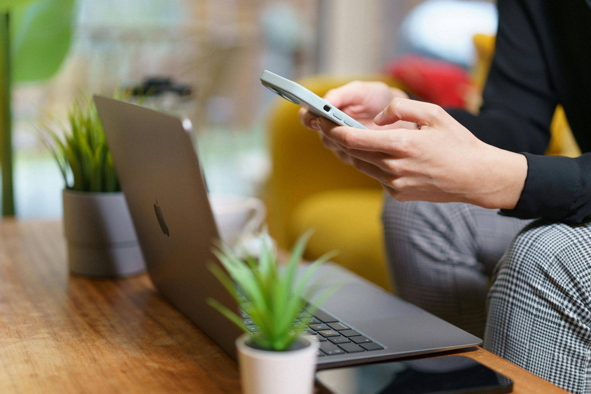 Person on phone and laptop