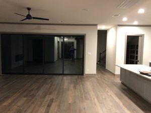 A living room with sliding glass doors and a ceiling fan.