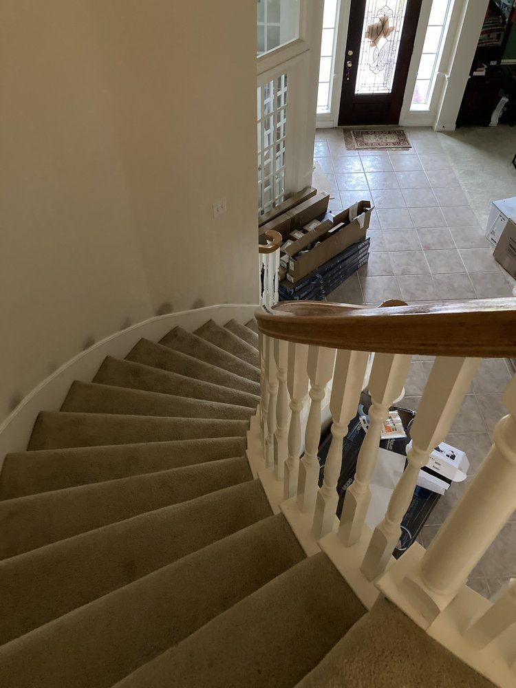 A spiral staircase in a house with a wooden railing