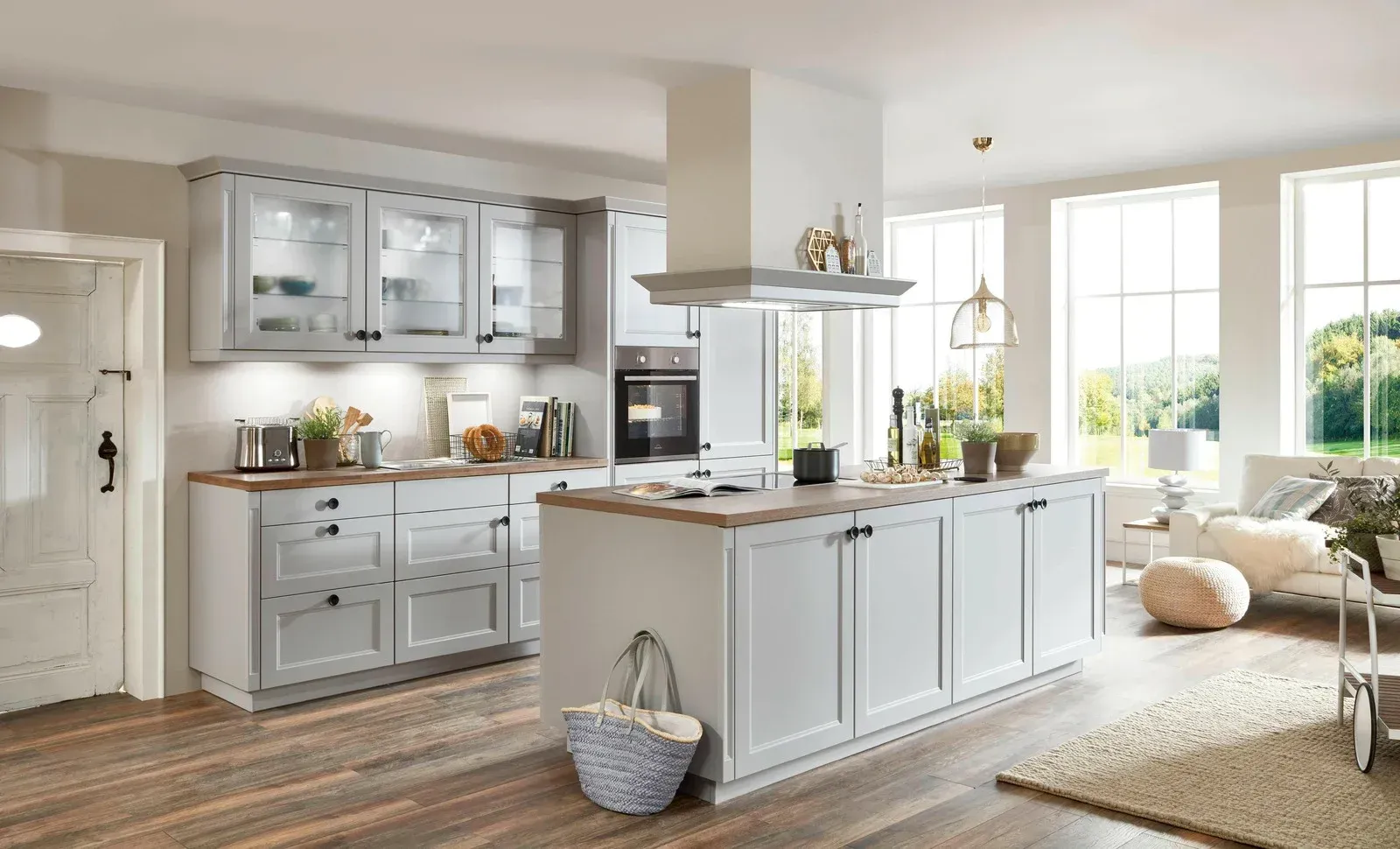 A kitchen with white cabinets and a large island in the middle of the room.
