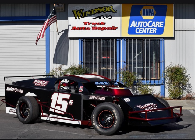 black race car in front of shop | Windsor Truck and Auto