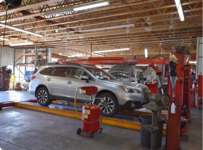 silver suv on car lift | Windsor Truck Auto