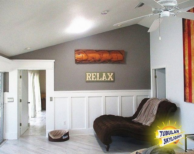 A living room with a sign on the wall that says relax.