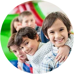 a group of young boys are standing in a circle and smiling for the camera .