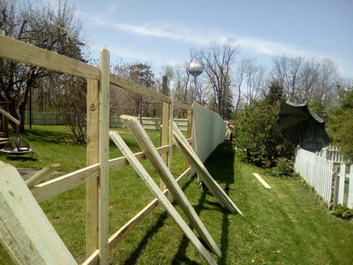 Family next to a fence done by our fencing contractor in Newark, OH