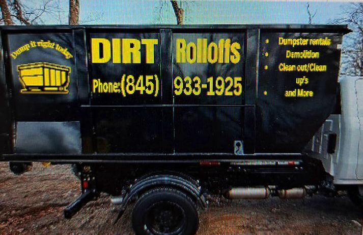 Black roll-off dumpster truck with yellow lettering.