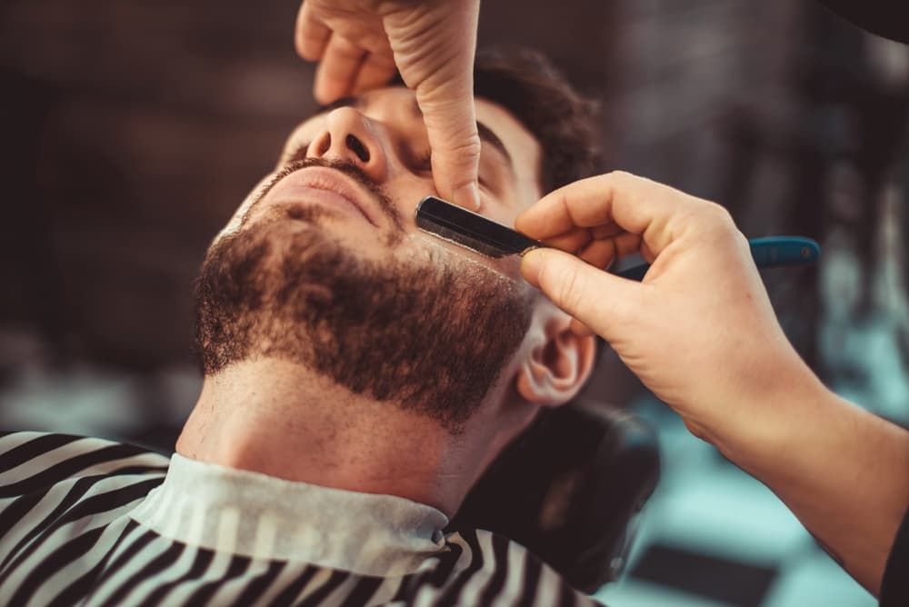 Barber Shaving A Bearded Man In A Barber Shop - Barber in Ballarat , VIC