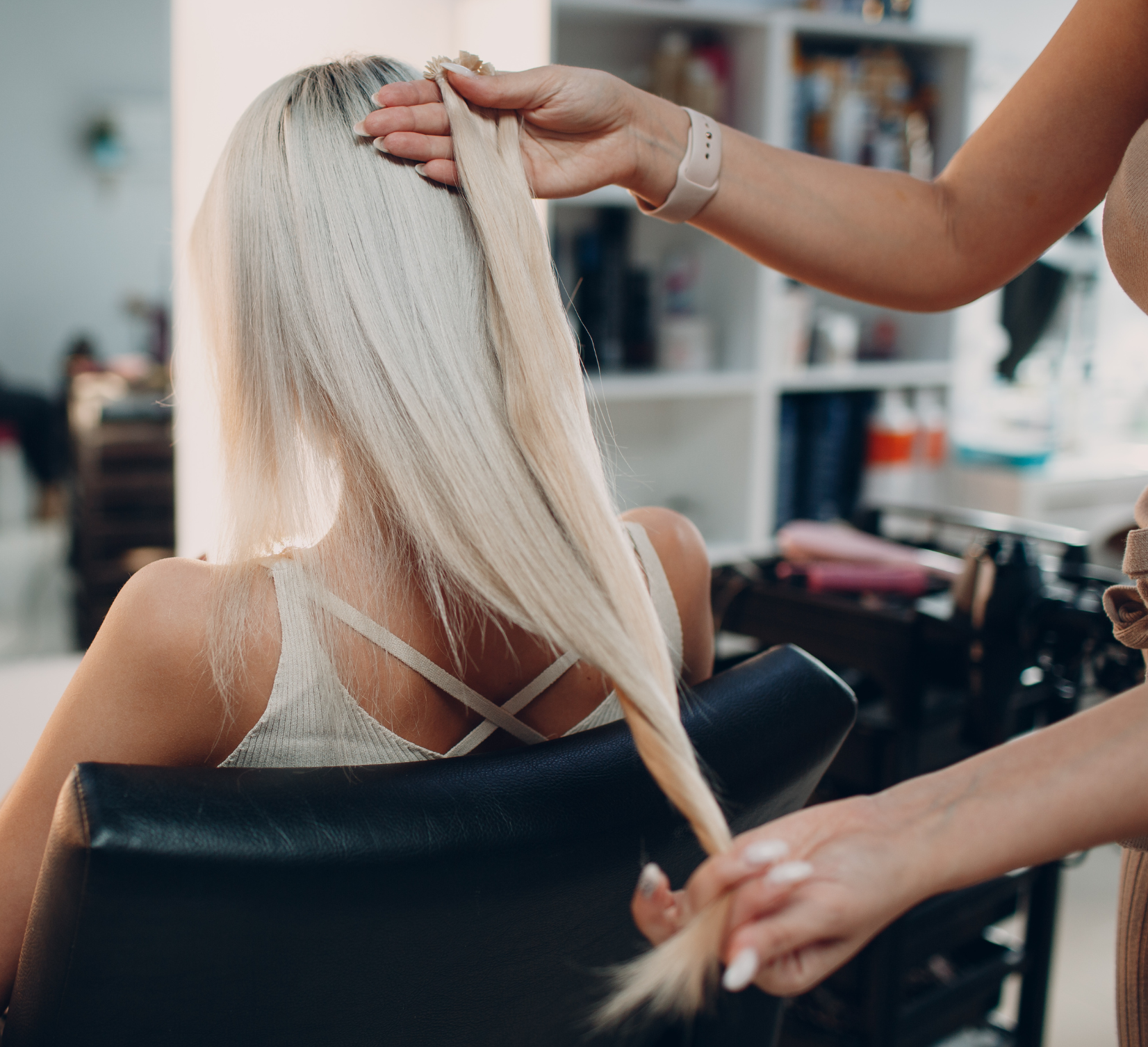 Hairdresser Applying Hair Extensions To A Client's Hair - Salon in Ballarat, VIC