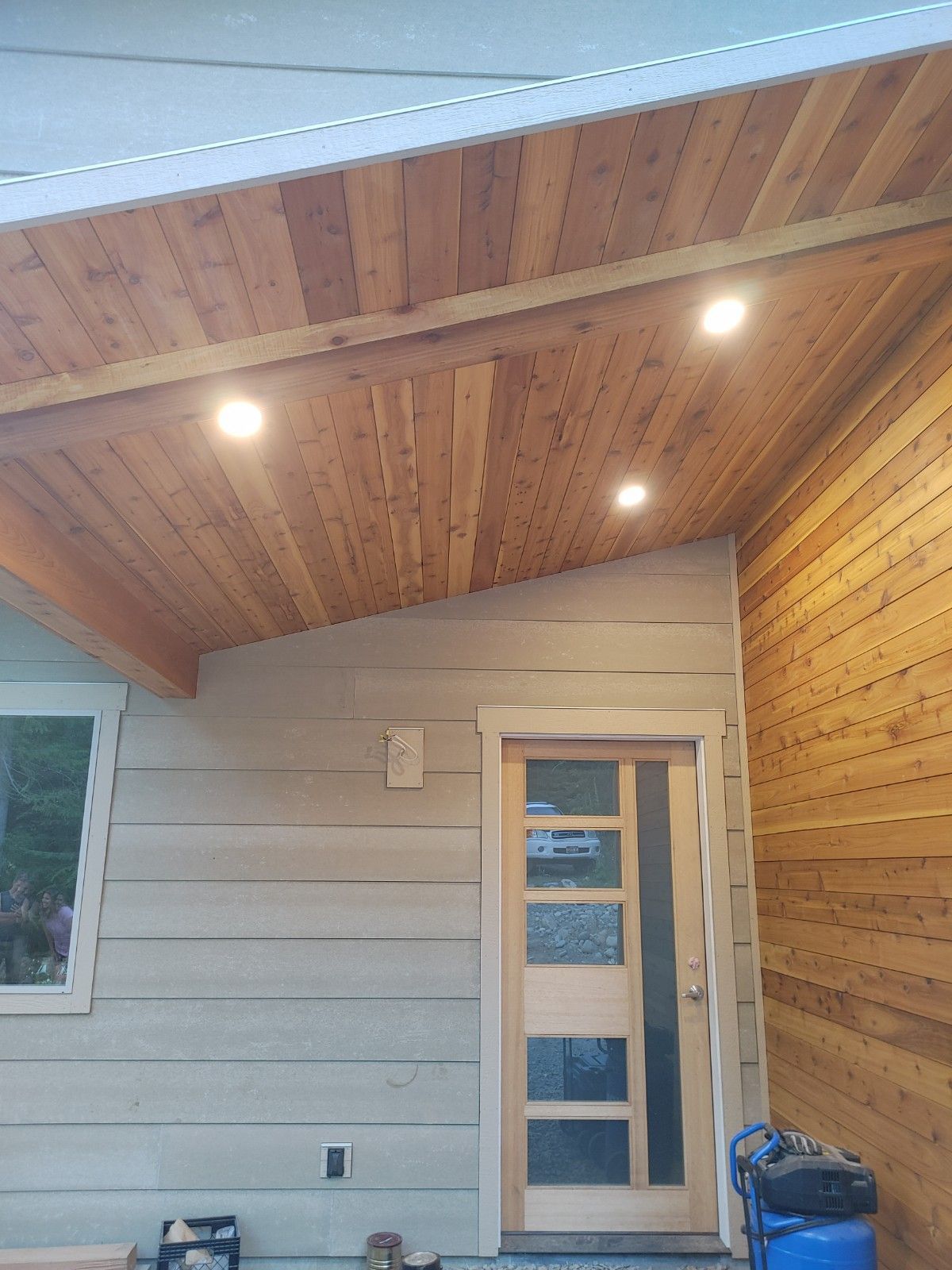 A house with a wooden ceiling and a wooden door.