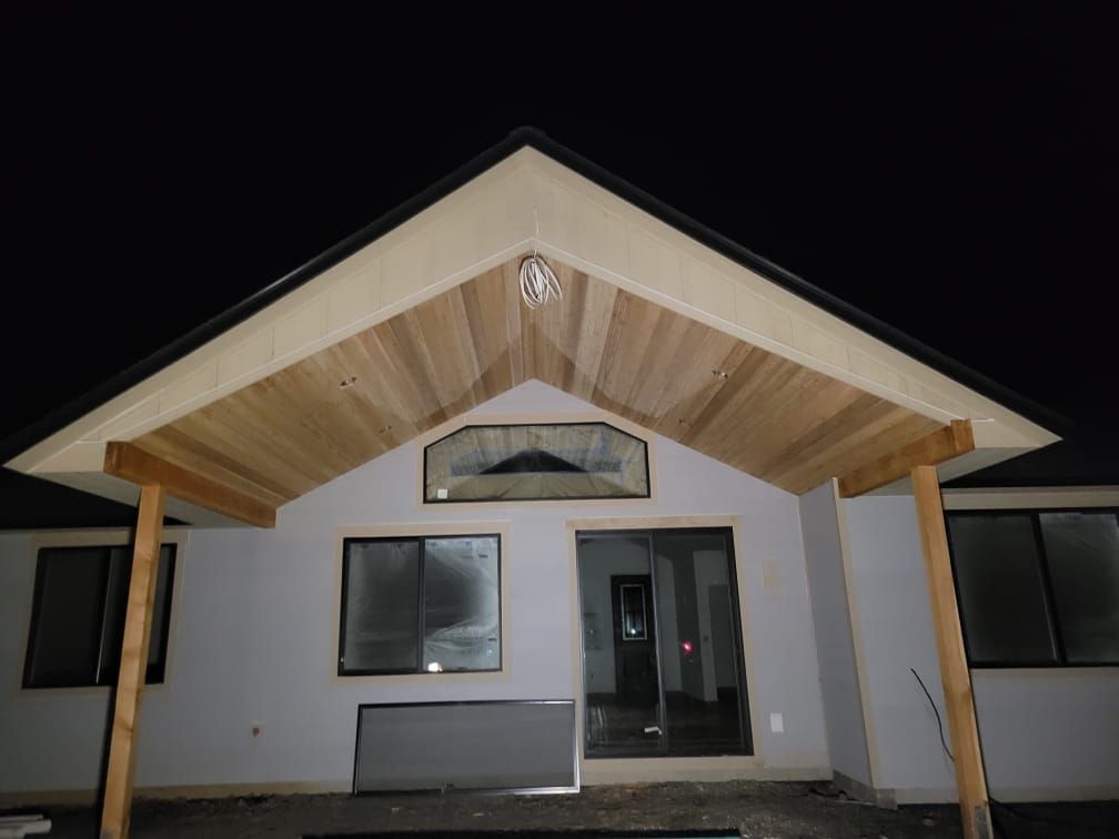 A house with a wooden roof is lit up at night