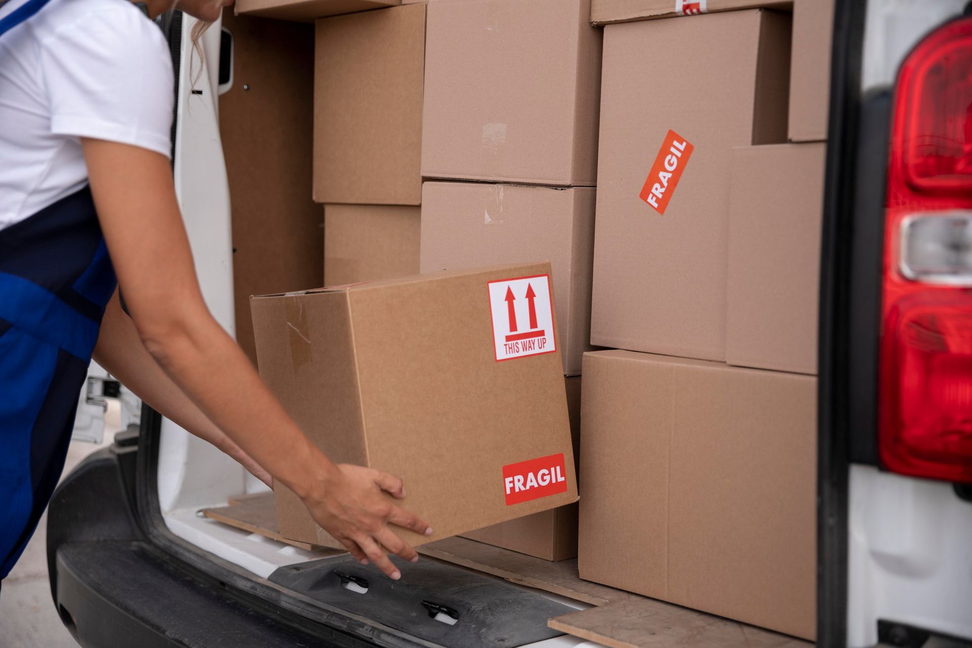 professional mover putting boxes in a van