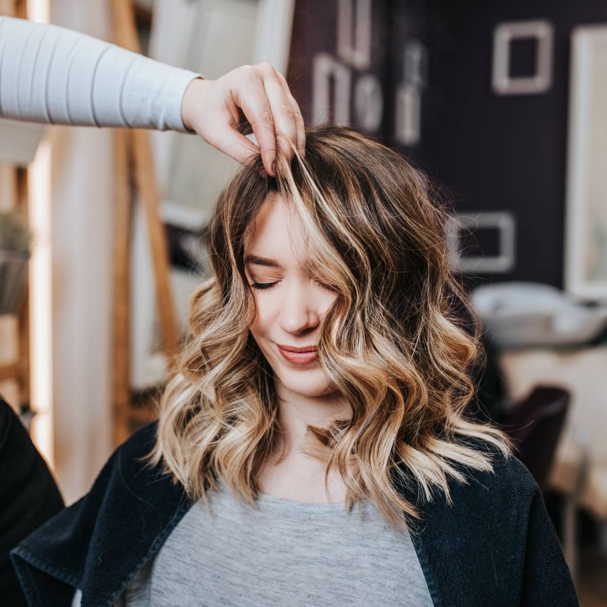A woman is getting her hair done at a salon.