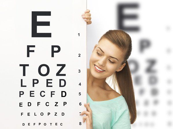 Woman reading eye exam chart