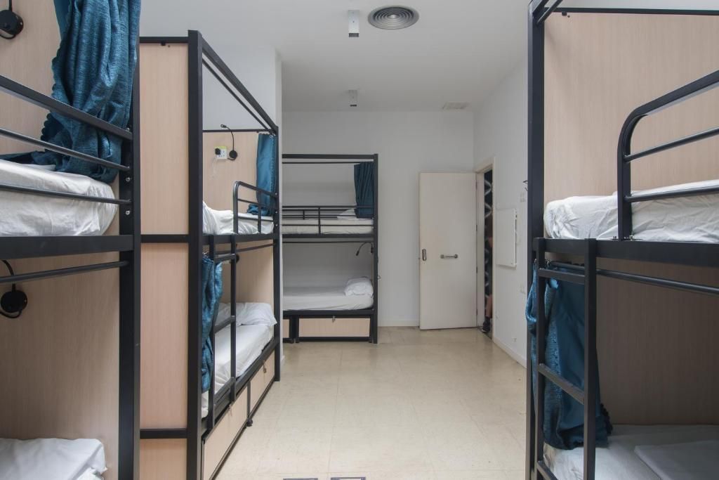 A room filled with bunk beds and a door