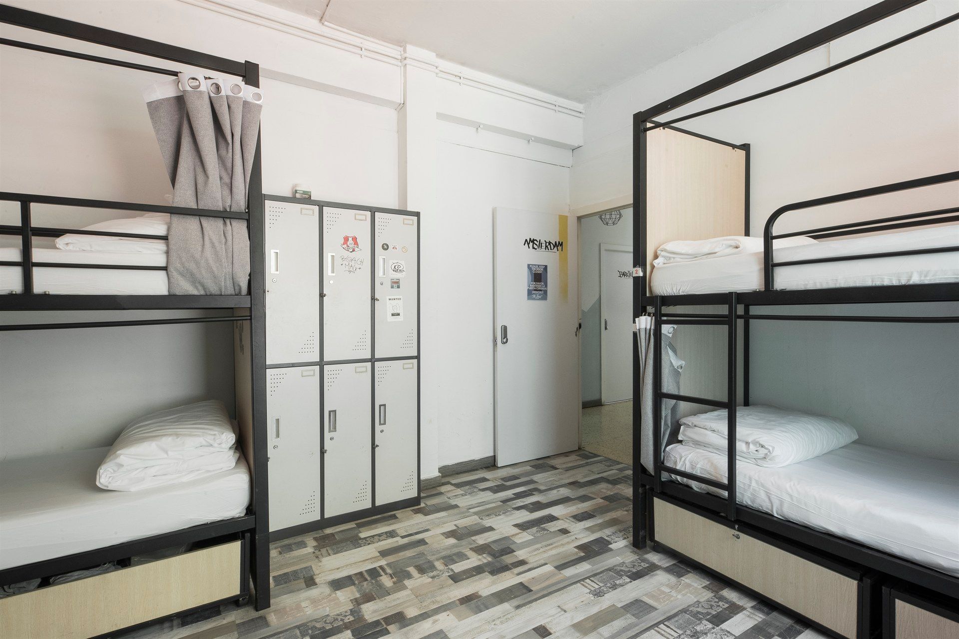 A room with bunk beds and lockers in it.