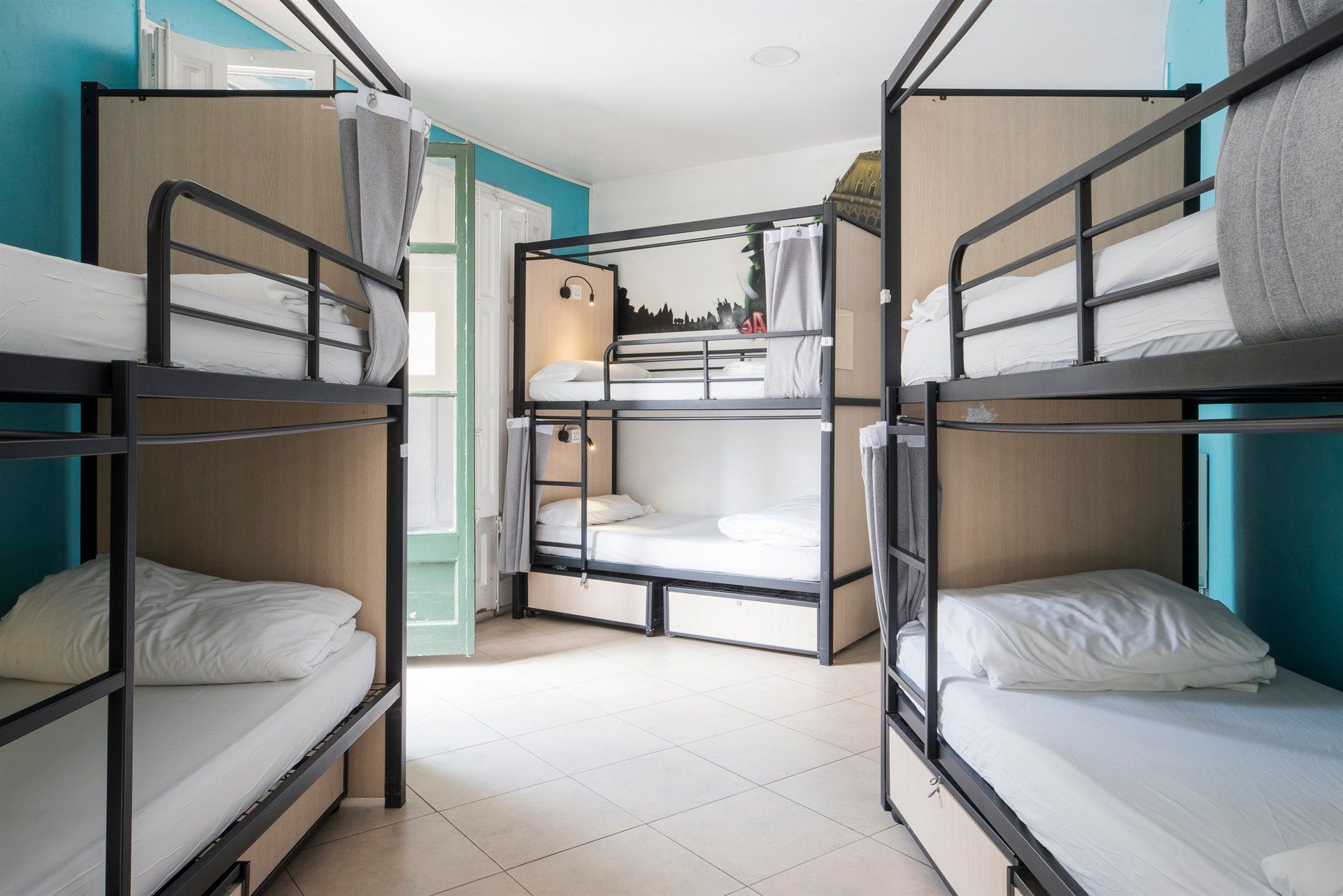 A room filled with bunk beds in a hostel.