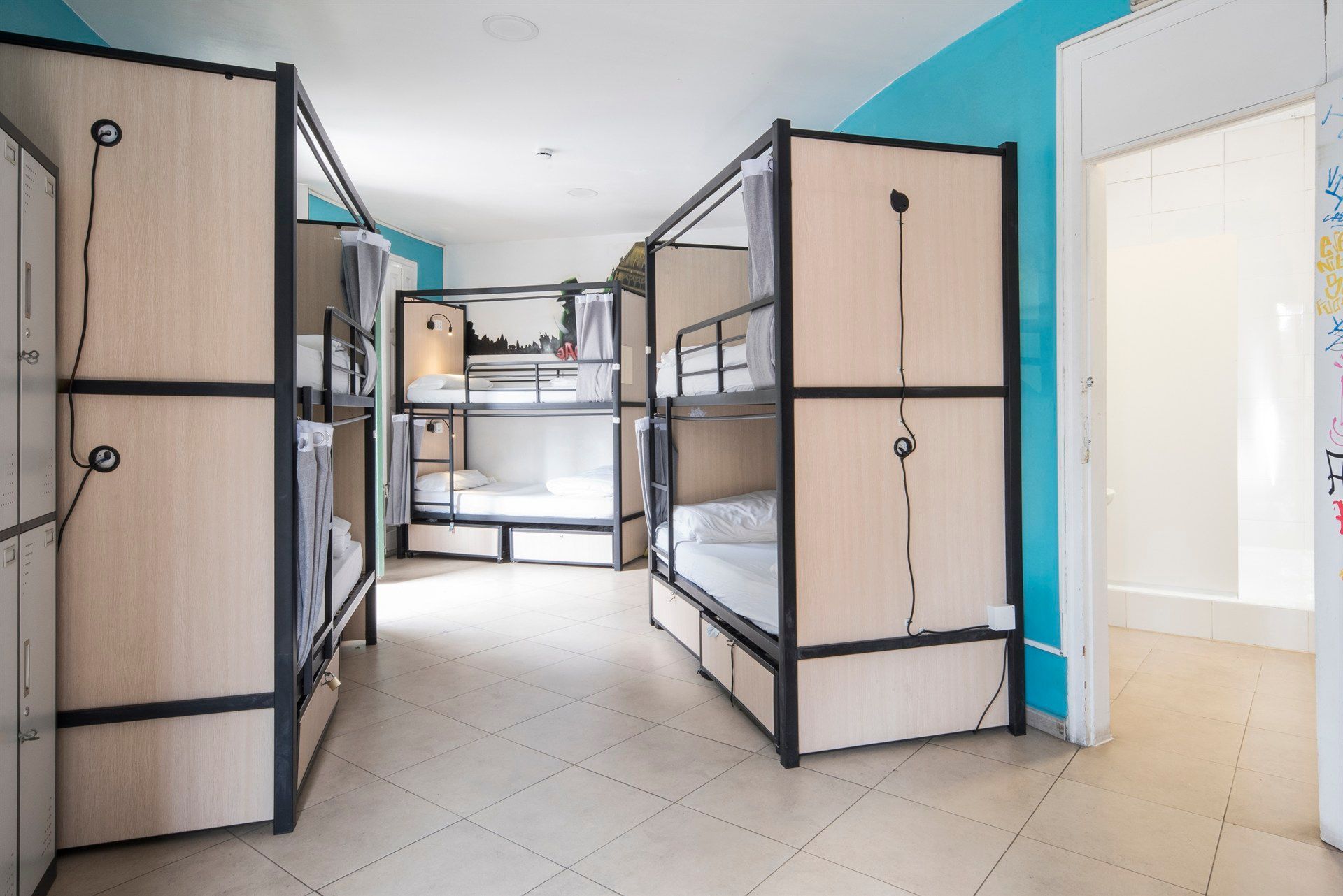 A room filled with bunk beds and lockers.