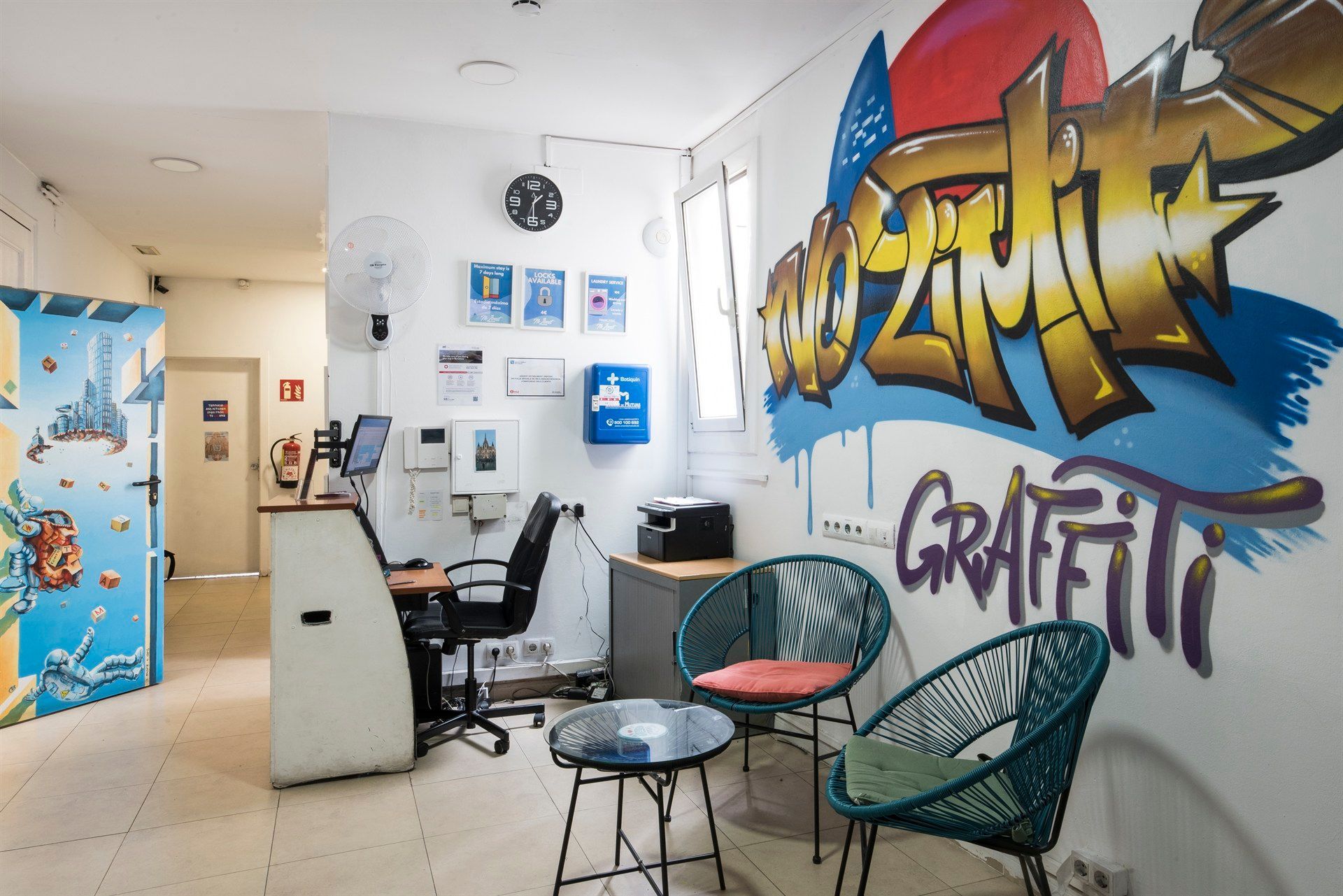 A room with graffiti on the wall and chairs