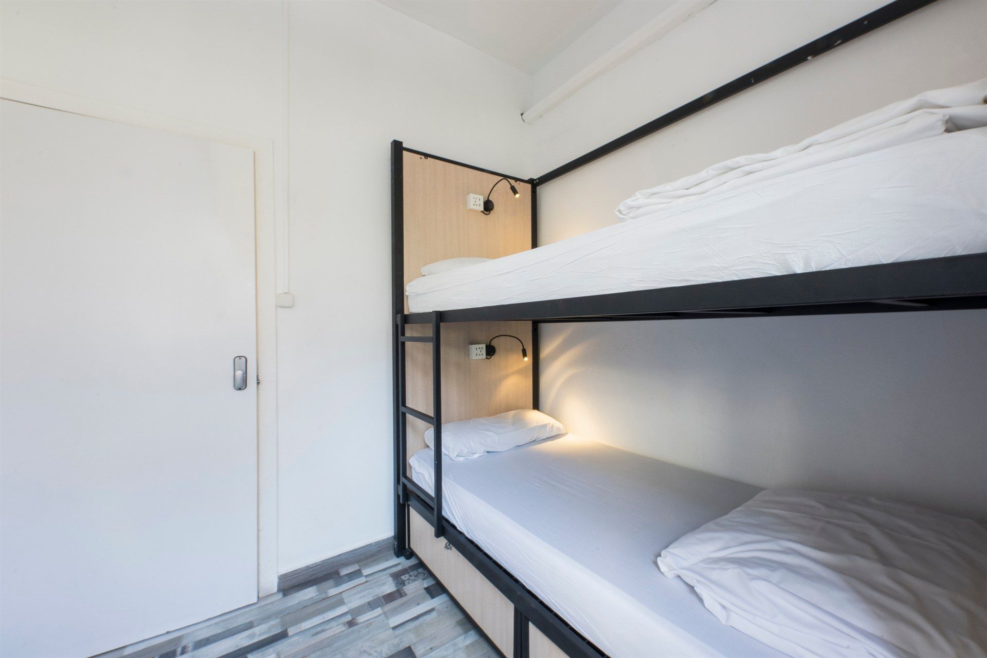 A room with two bunk beds and a door