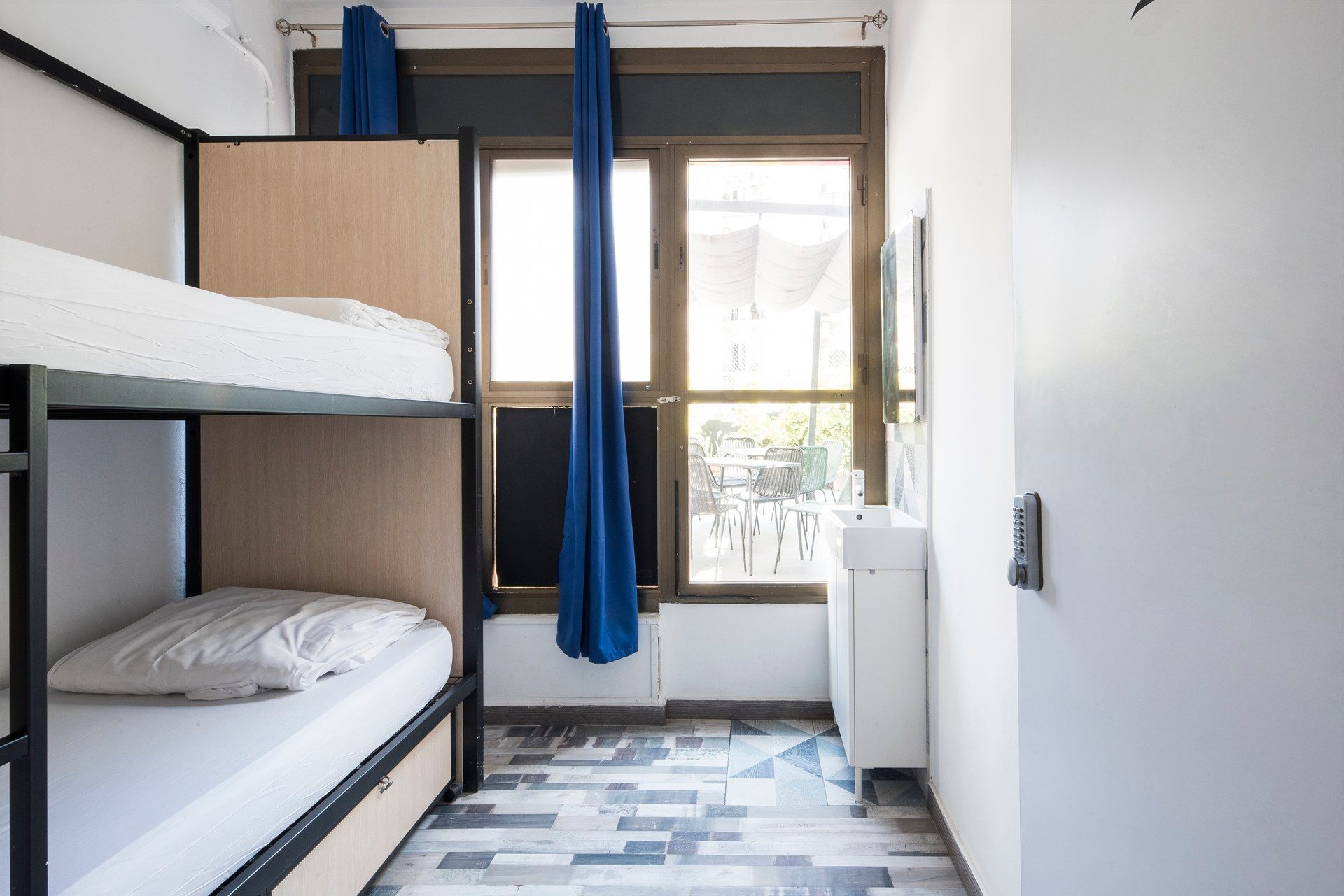 A room with bunk beds and a sink in it