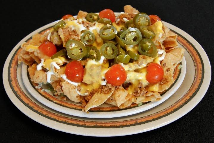 Cheese quesadilla slices on a red plate with sour cream, salsa, and shredded lettuce