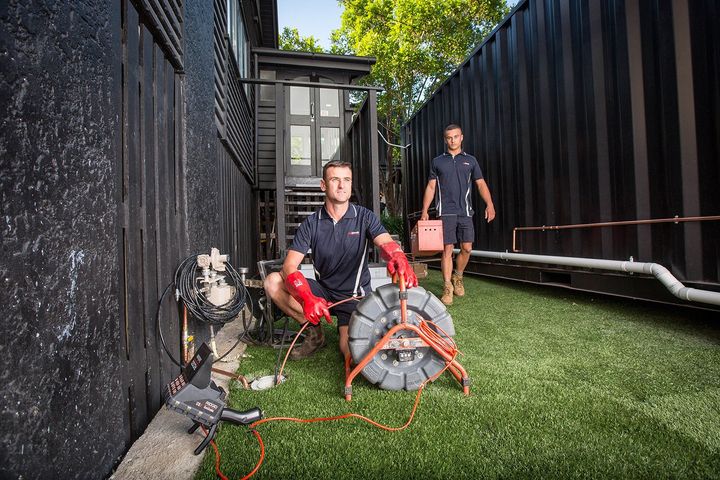 Two Plumbers Using a Drain Snake — Unblock Pipe Clearing in Mullumbimby, NSW