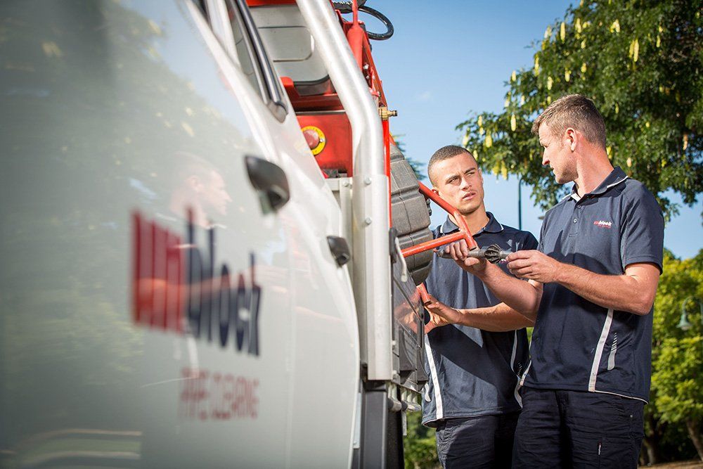 Plumbers Talking Beside Their Vehicle — Unblock Pipe Clearing in the Mullumbimby, NSW