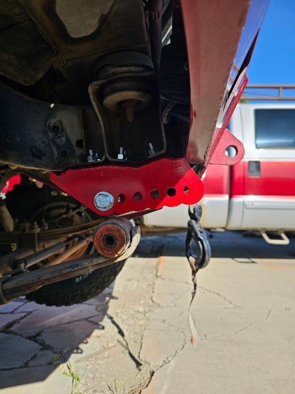 Comparison: rusty vehicle part replaced with a new, red metal part. Instructions: