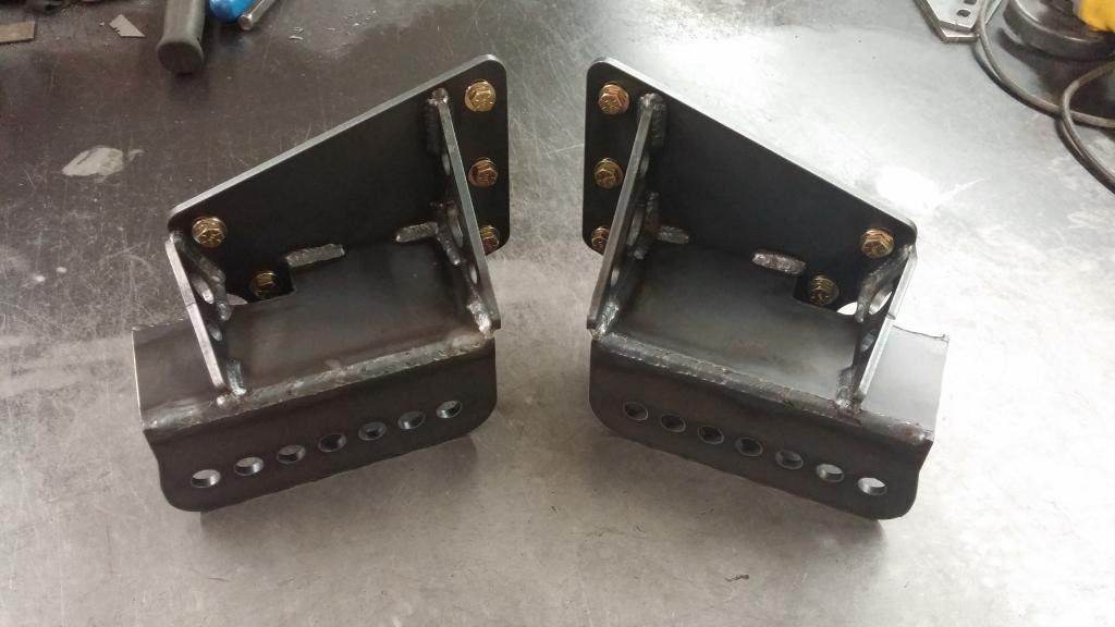 Two stainless steel mounting brackets with CFM cutouts and bolt-on hardware.