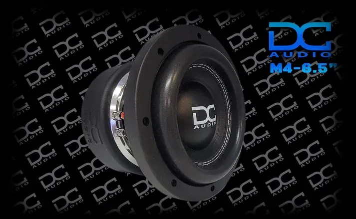 A dc audio m4 6.5 subwoofer is sitting on a black background