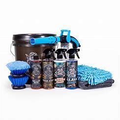 Car washing kit with spray bottles, bucket, and cleaning tools.