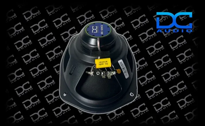 DC Audio Pro Audio Series car speaker components and box on a black background.