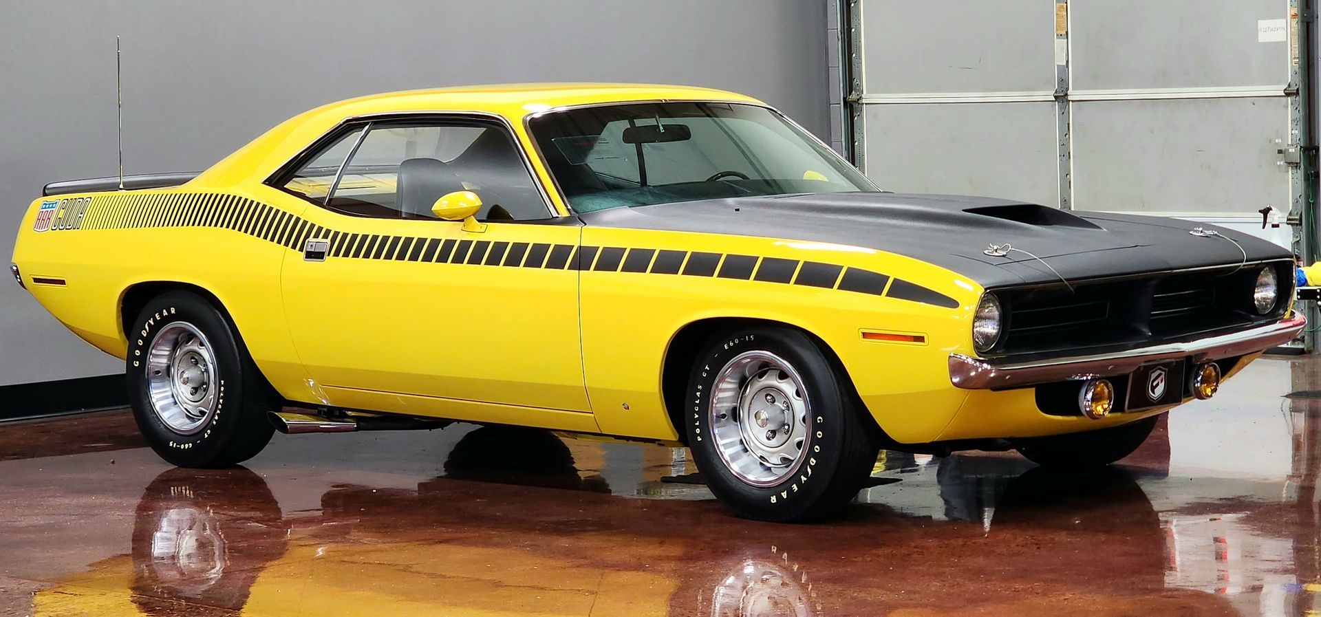 Yellow and black Plymouth Barracuda muscle car.
