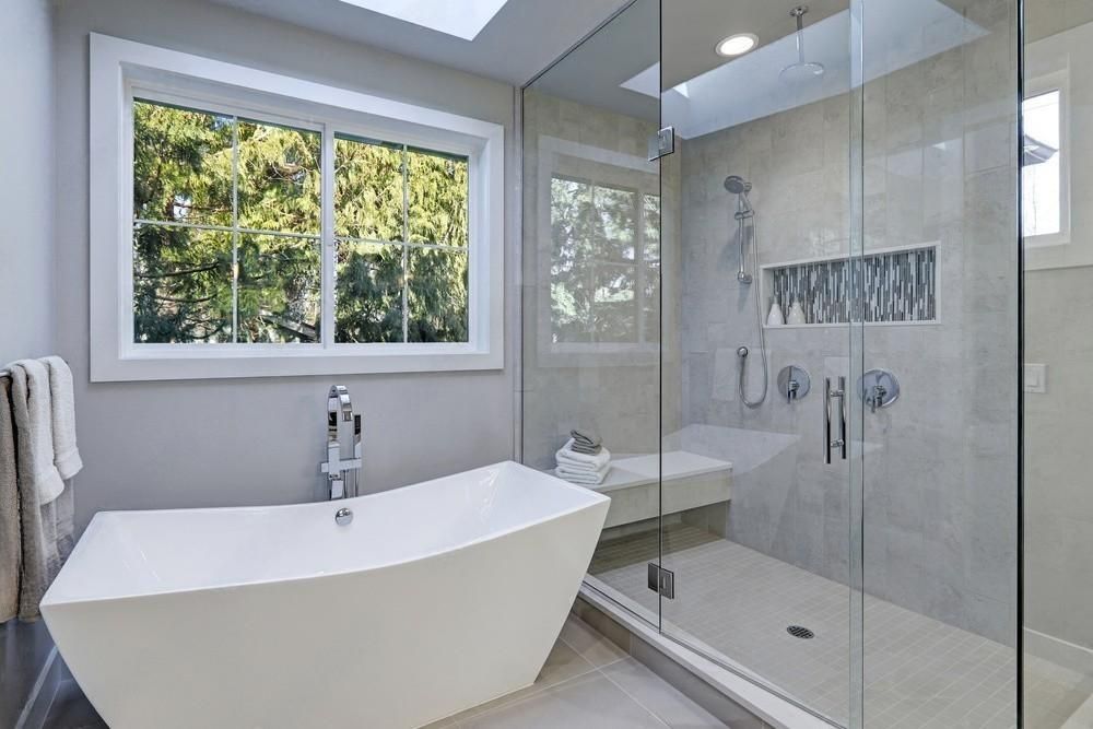 a bathroom with a bathtub and a walk in shower .