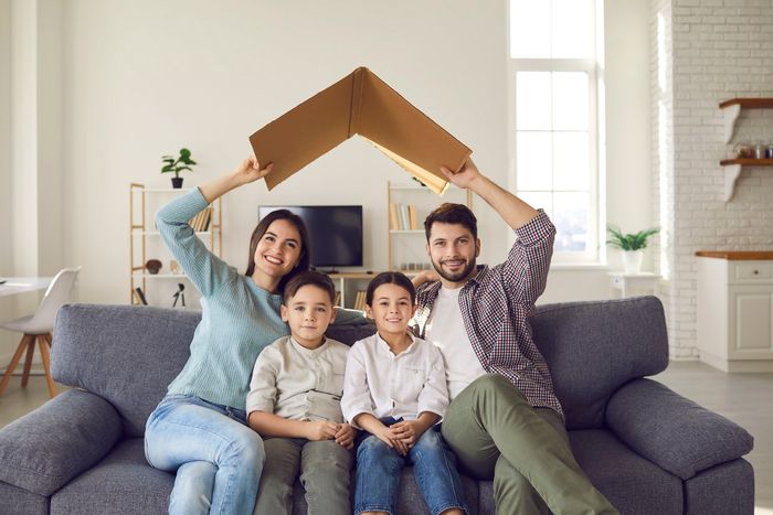 Family of Four Sitting on Couch at Home — Rising Sun, MD — Crothers Insurance Agency