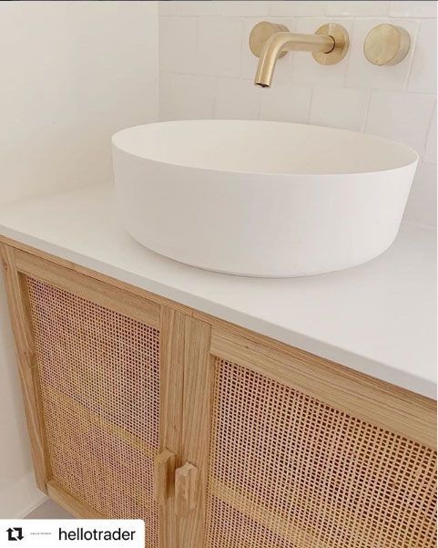 A Bathroom Sink With A Wicker Cabinet Underneath It — Southeast Stone Pty Ltd In Caloundra West, QLD