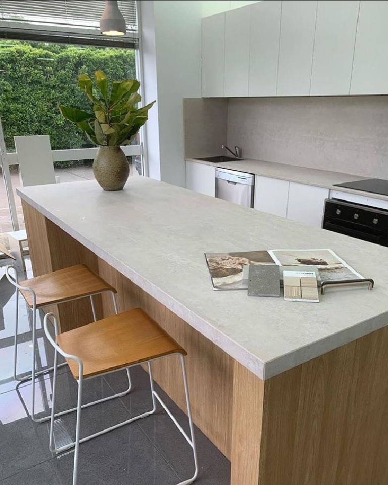 A Kitchen With A Large Island And Stools And A Plant On The Counter — Southeast Stone Pty Ltd In Noosa, QLD