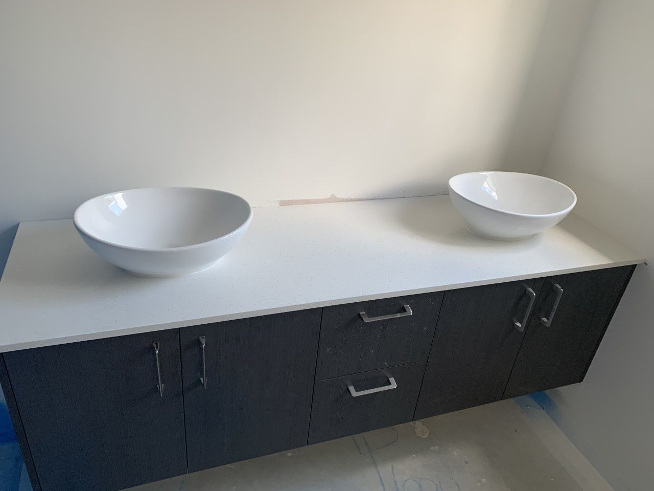 Two White Bowls Are Sitting On A Counter In A Bathroom — Southeast Stone Pty Ltd In Caloundra West, QLD