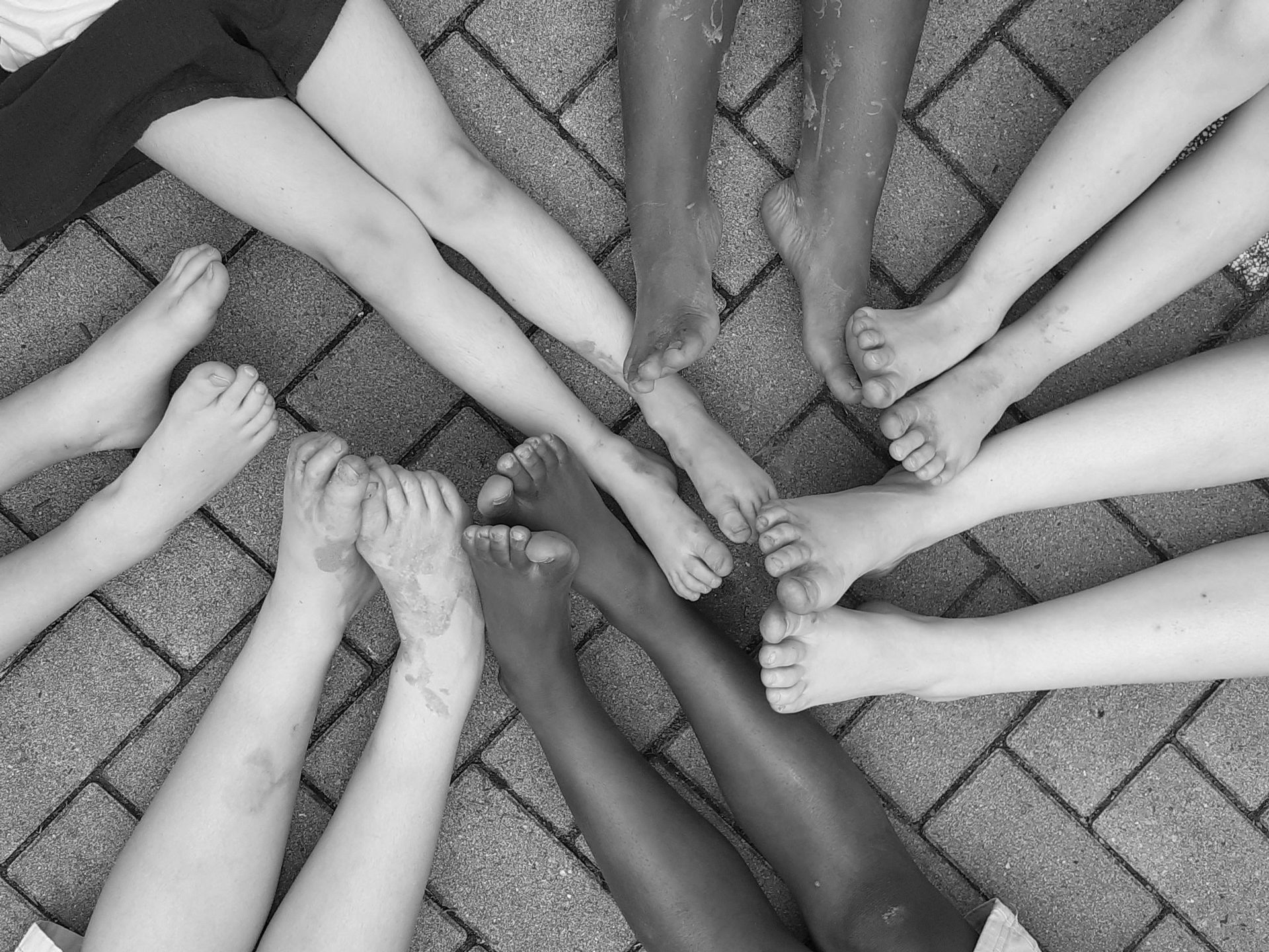 Two people are holding hands in a black and white photo.
