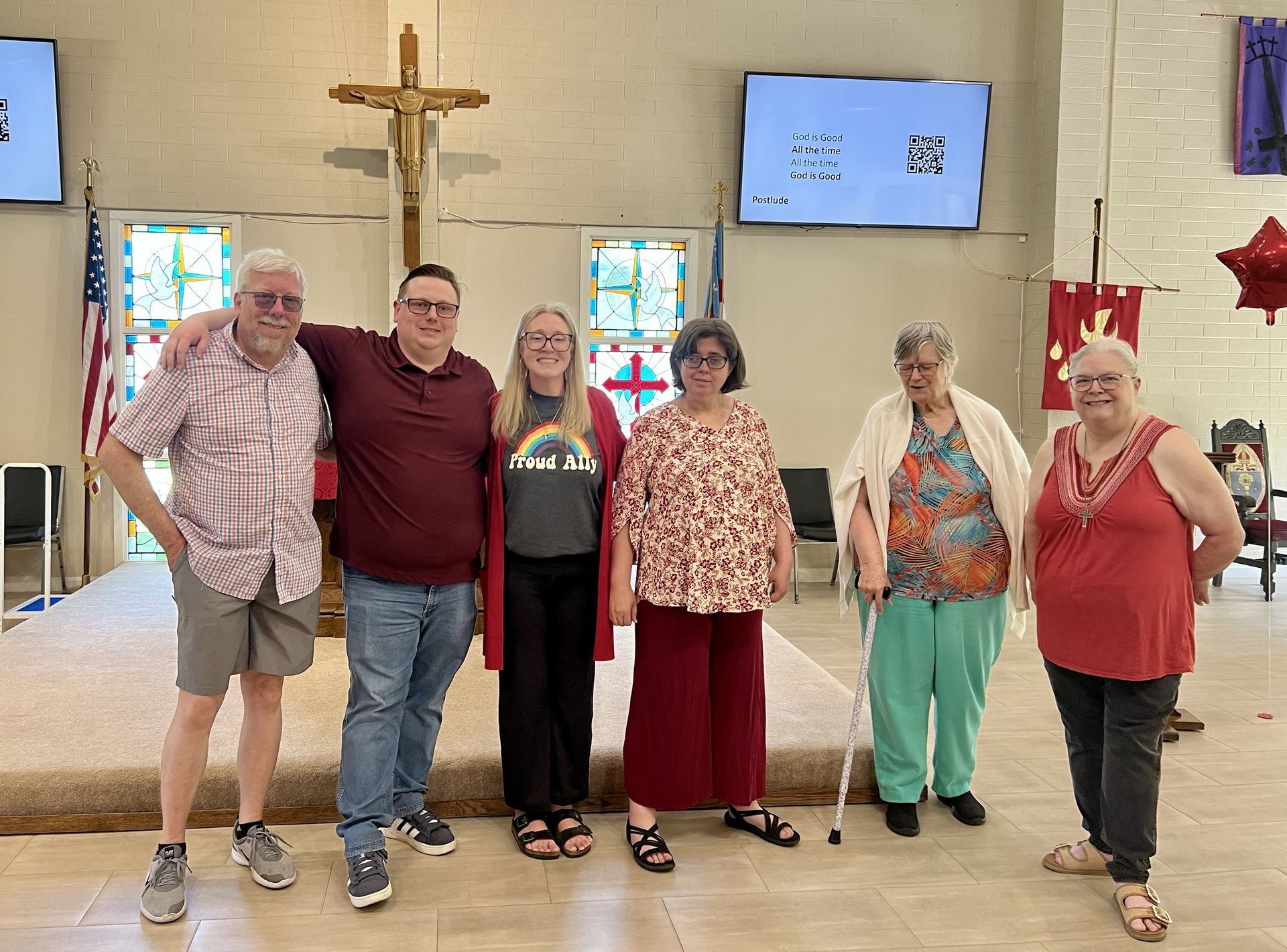 Six people are standing in the Sanctuary facing the congregation. 