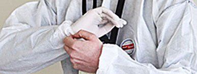 Asbestos tester putting on gloves