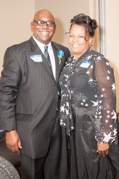 man and woman standing and smiling