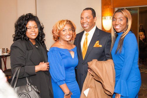 three girls smiling and a man