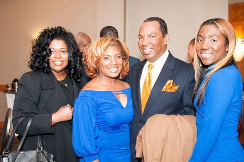 three girls smiling and a man