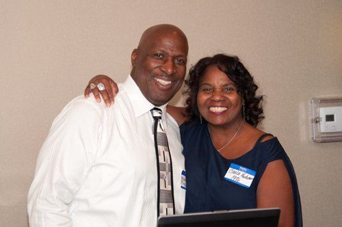 man in white polo and smiling girl